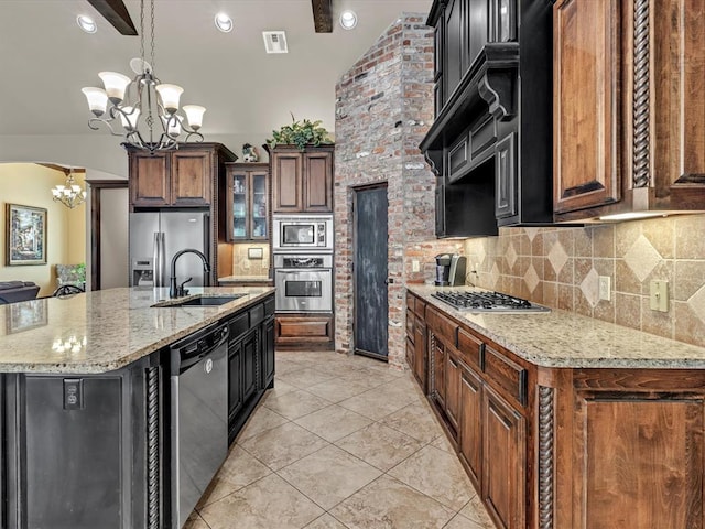13401 Grapevine Trl, Oklahoma City, OK 73170 - kitchen featuring appliances with stainless steel finishes, a chandelier, a sink, backsplash, and glass insert cabinets