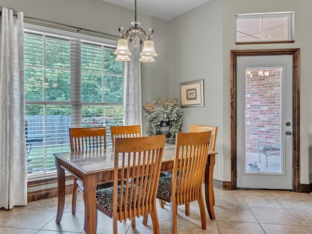 13401 Grapevine Trl, Oklahoma City, OK 73170 - dining room with a chandelier, light tile patterned floors, and baseboards