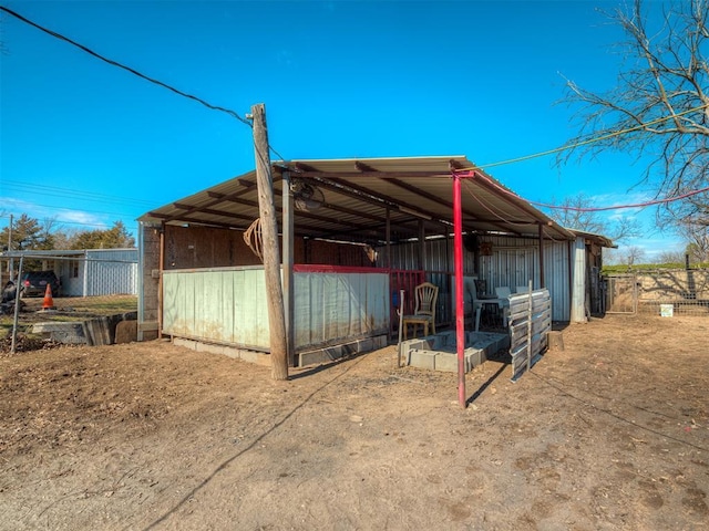 view of outdoor structure featuring an exterior structure, an outdoor structure, and a carport