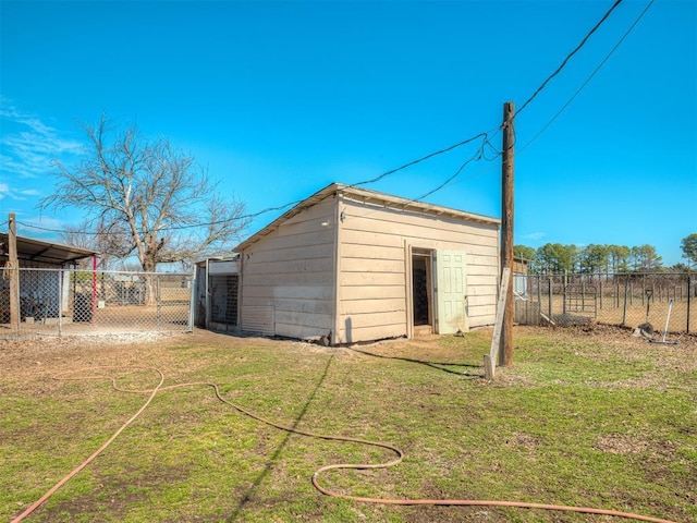 view of outbuilding with fence and an outbuilding