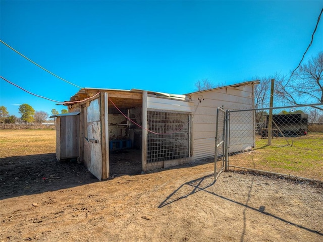 view of outdoor structure featuring an outbuilding and fence