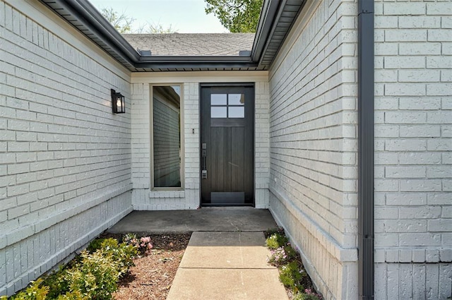 1804 Foxfire Rd, Edmond, OK 73003 - doorway to property with brick siding and roof with shingles