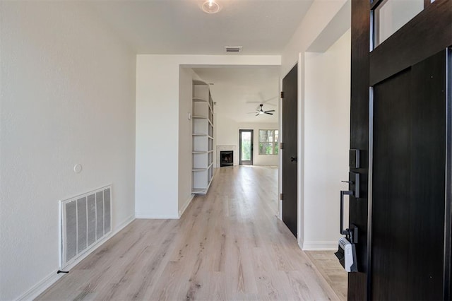 1804 Foxfire Rd, Edmond, OK 73003 - hall featuring baseboards, visible vents, and light wood-style floors