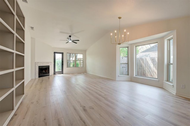 1804 Foxfire Rd, Edmond, OK 73003 - unfurnished living room featuring wood finished floors, ceiling fan with notable chandelier, a fireplace, lofted ceiling, and visible vents