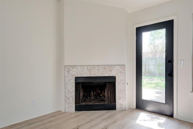 1804 Foxfire Rd, Edmond, OK 73003 - details featuring a tiled fireplace and wood finished floors