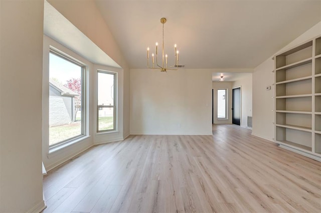 1804 Foxfire Rd, Edmond, OK 73003 - interior space with an inviting chandelier, light wood finished floors, baseboards, lofted ceiling, and visible vents
