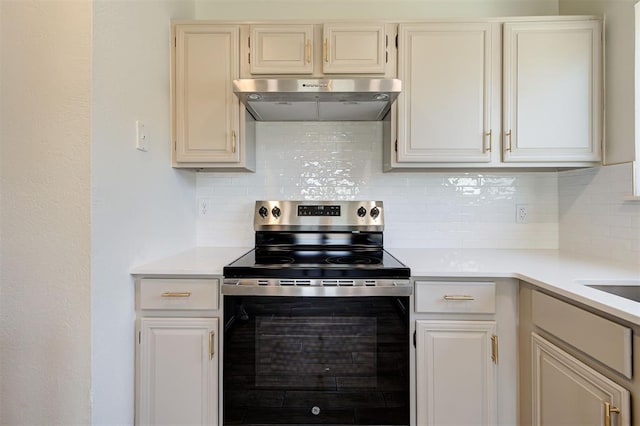 1804 Foxfire Rd, Edmond, OK 73003 - kitchen with light countertops, extractor fan, stainless steel range with electric stovetop, and decorative backsplash