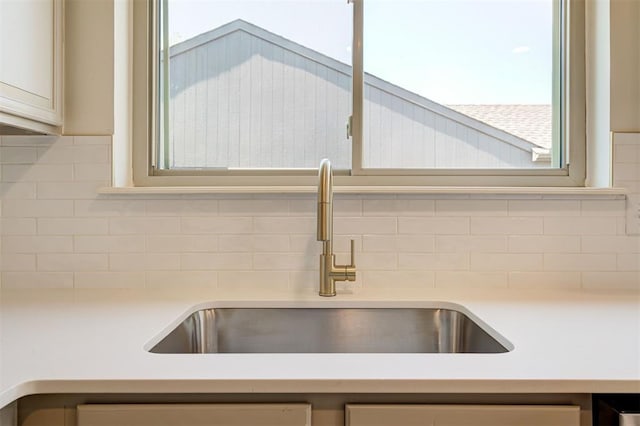 1804 Foxfire Rd, Edmond, OK 73003 - interior details featuring light countertops, a sink, and tasteful backsplash