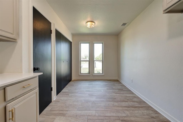 1804 Foxfire Rd, Edmond, OK 73003 - interior space featuring light wood-style floors, visible vents, and baseboards