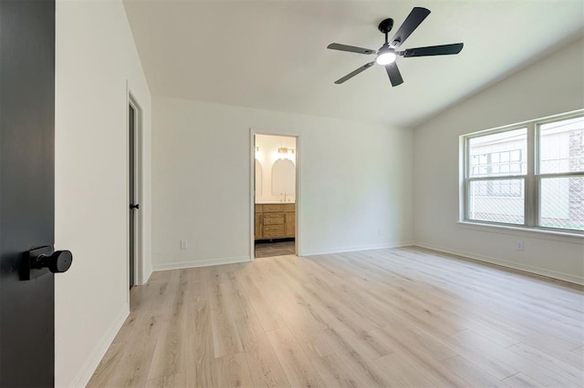 1804 Foxfire Rd, Edmond, OK 73003 - unfurnished bedroom featuring lofted ceiling, baseboards, and light wood-style floors