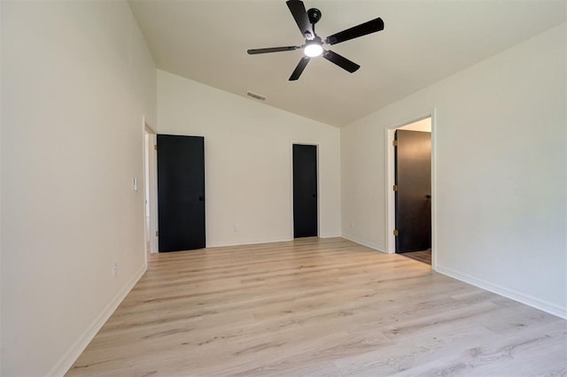 1804 Foxfire Rd, Edmond, OK 73003 - empty room with light wood finished floors, vaulted ceiling, visible vents, a ceiling fan, and baseboards