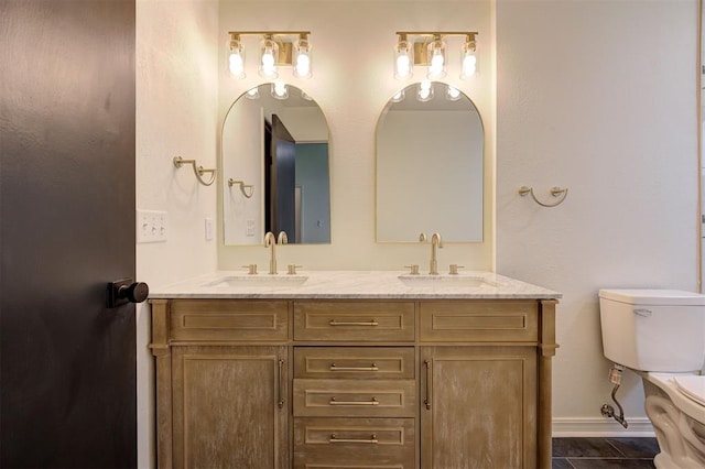 1804 Foxfire Rd, Edmond, OK 73003 - full bath with double vanity, toilet, baseboards, and a sink