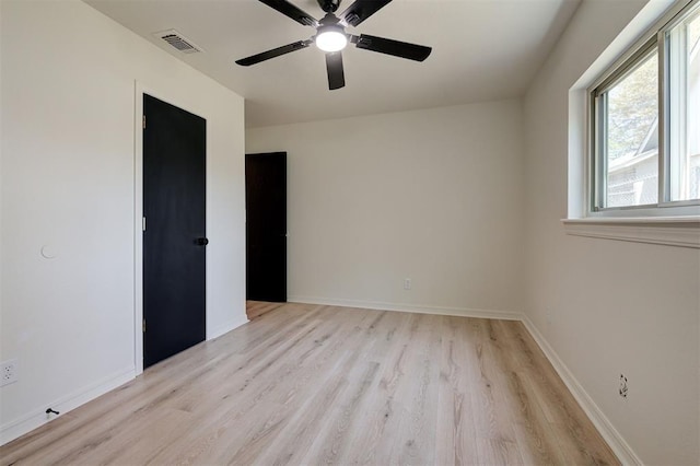 1804 Foxfire Rd, Edmond, OK 73003 - spare room featuring baseboards, light wood-style flooring, visible vents, and a ceiling fan