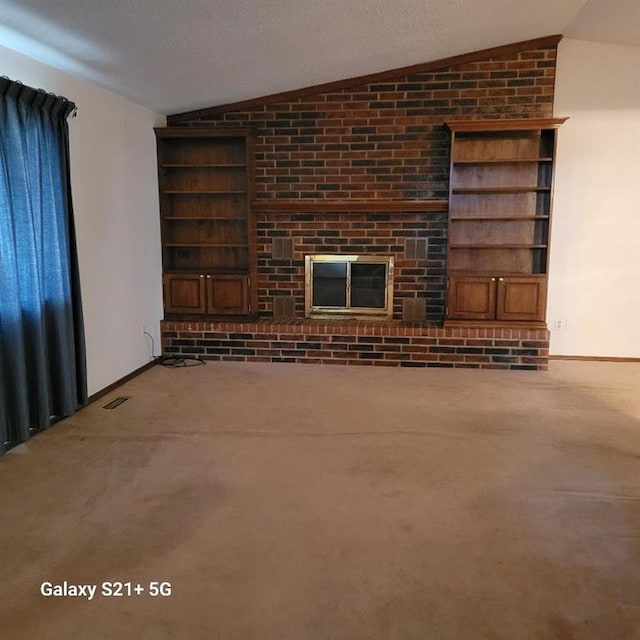 unfurnished living room with visible vents, carpet floors, baseboards, vaulted ceiling, and built in shelves