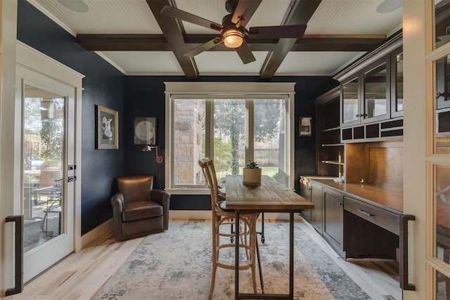 office featuring light wood-style flooring, ceiling fan, coffered ceiling, and beamed ceiling