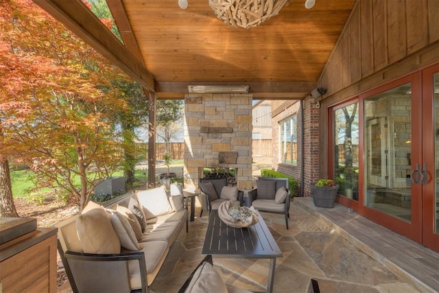 view of patio with an outdoor living space with a fireplace