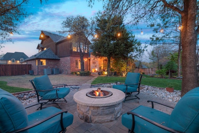view of patio featuring fence and a fire pit