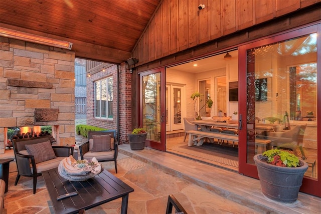 view of patio with an outdoor living space with a fireplace