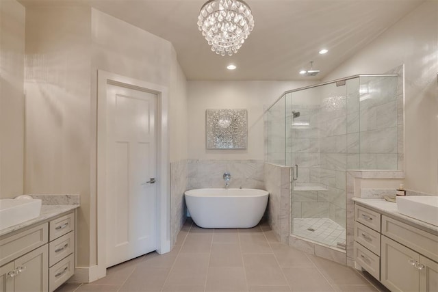 full bath with vanity, tile patterned floors, a freestanding bath, and a stall shower