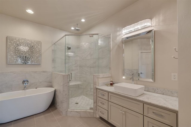 full bath featuring a freestanding tub, tile patterned flooring, a shower stall, vanity, and recessed lighting