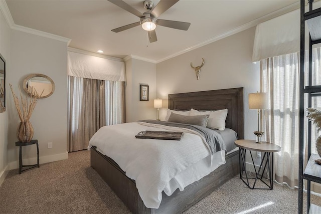 carpeted bedroom featuring crown molding, baseboards, and ceiling fan