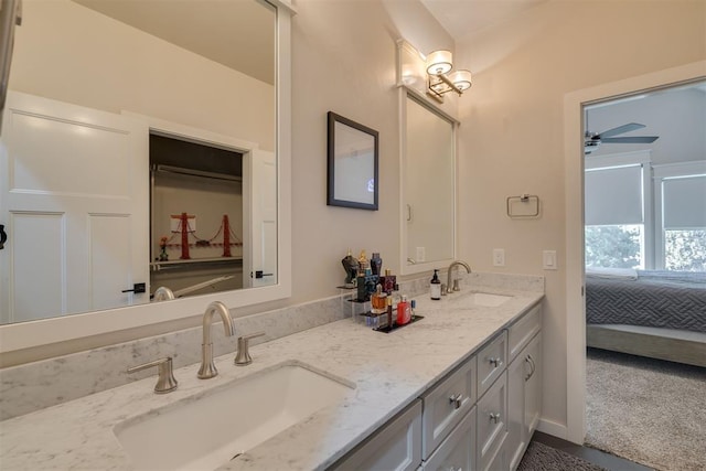 bathroom with a sink, double vanity, and connected bathroom