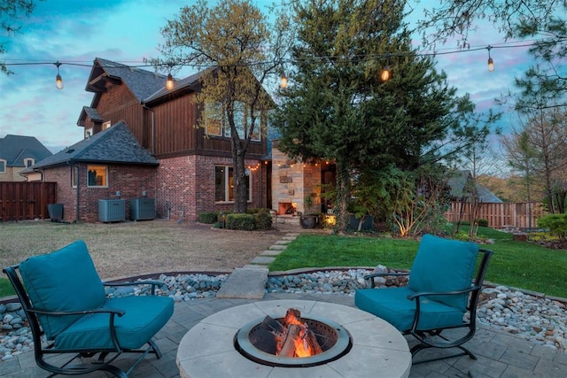 view of patio / terrace featuring a fenced backyard, a fire pit, and cooling unit