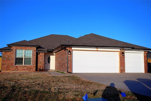 single story home with a front lawn, driveway, an attached garage, brick siding, and roof with shingles