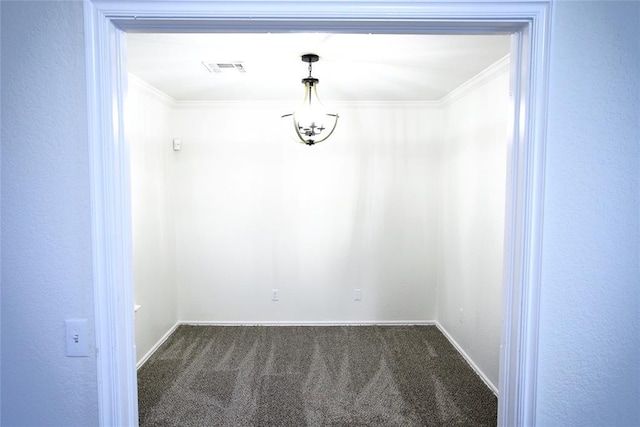 spare room featuring dark carpet, baseboards, crown molding, and visible vents