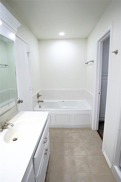 full bathroom featuring recessed lighting, a bath, tile patterned flooring, and vanity