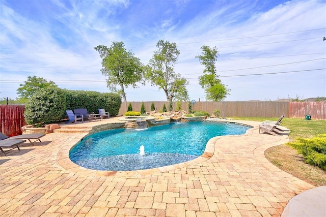 view of swimming pool featuring a patio, a fenced backyard, and a pool with connected hot tub