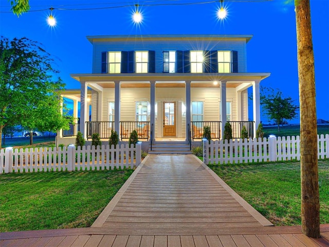 18443 Boardwalk Xing, Norman, OK 73072 - view of front of home featuring a front lawn, a fenced front yard, and a porch
