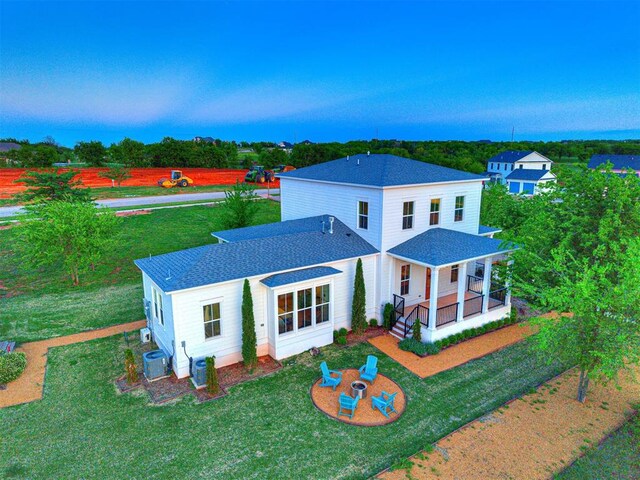 18443 Boardwalk Xing, Norman, OK 73072 - rear view of house featuring a shingled roof, central AC unit, and a lawn
