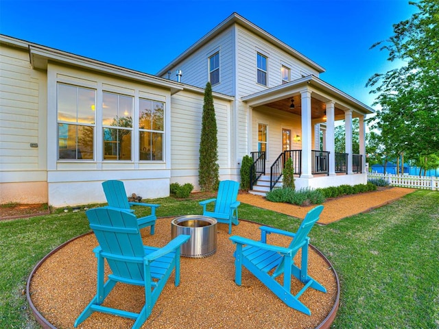 18443 Boardwalk Xing, Norman, OK 73072 - back of house featuring a fire pit, a ceiling fan, a lawn, and a porch