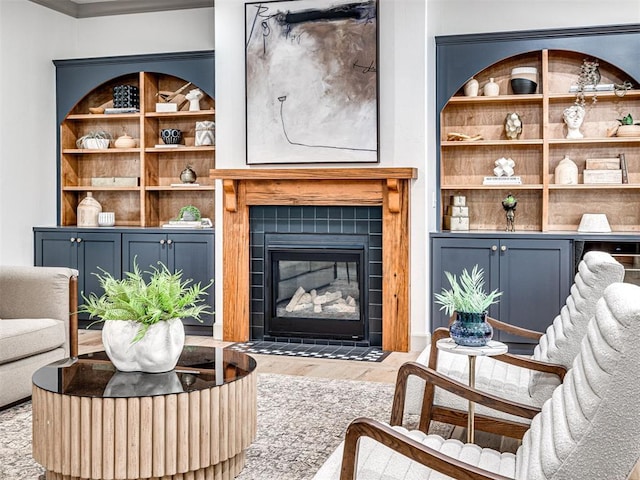 18443 Boardwalk Xing, Norman, OK 73072 - living room with a tile fireplace, wood finished floors, and built in shelves