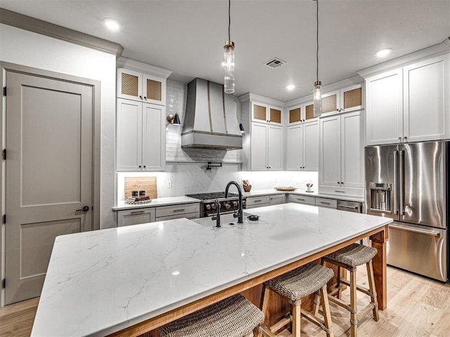 18443 Boardwalk Xing, Norman, OK 73072 - kitchen featuring light wood-type flooring, wall chimney range hood, high end refrigerator, and a sink