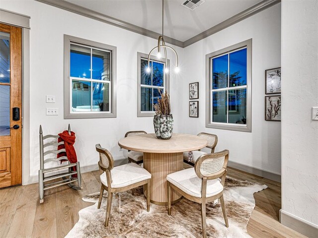 18443 Boardwalk Xing, Norman, OK 73072 - dining space featuring baseboards, ornamental molding, visible vents, and wood finished floors