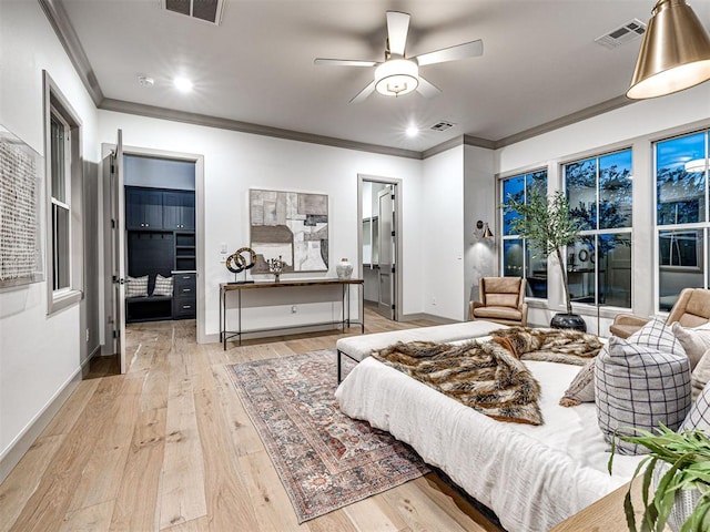 18443 Boardwalk Xing, Norman, OK 73072 - bedroom with a walk in closet, ornamental molding, and visible vents