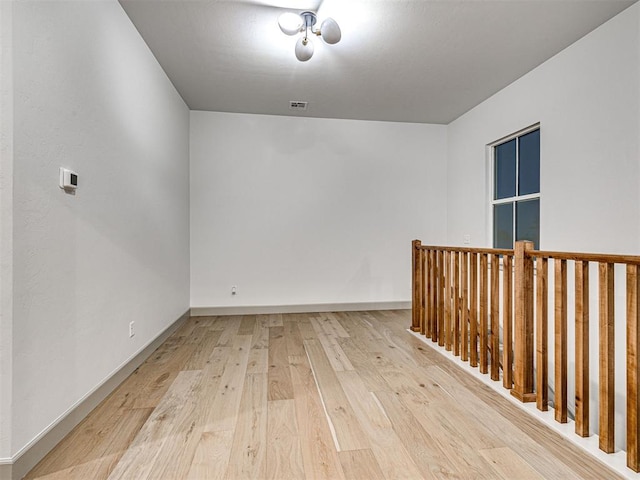 18443 Boardwalk Xing, Norman, OK 73072 - unfurnished room with visible vents, light wood-style flooring, and baseboards