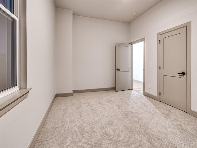 18443 Boardwalk Xing, Norman, OK 73072 - unfurnished room featuring baseboards and light carpet