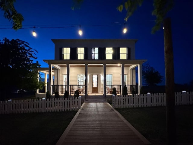 18443 Boardwalk Xing, Norman, OK 73072 - back of house at twilight with a fenced front yard and covered porch