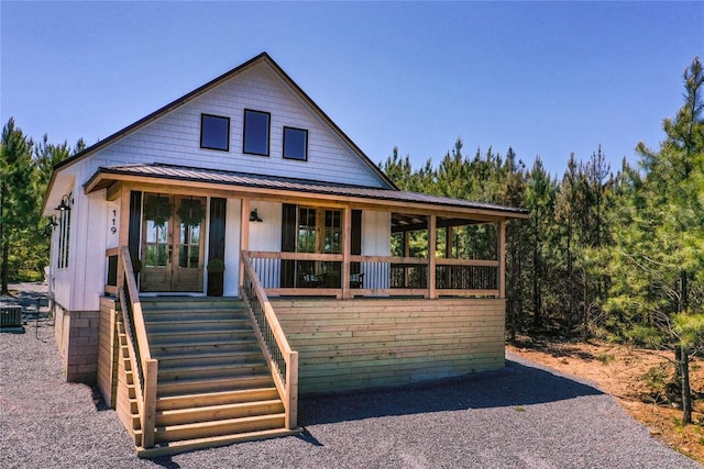119 Leadwood Trl, Broken Bow, OK 74728 - view of front of house featuring stairs, a standing seam roof, french doors, covered porch, and metal roof