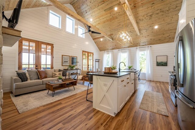 119 Leadwood Trl, Broken Bow, OK 74728 - kitchen with white cabinets, dark countertops, wood ceiling, appliances with stainless steel finishes, and high vaulted ceiling