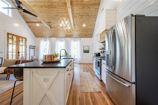 119 Leadwood Trl, Broken Bow, OK 74728 - kitchen with dark countertops, wood ceiling, stainless steel appliances, light wood-style flooring, and white cabinets