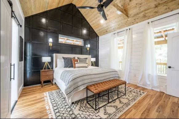 119 Leadwood Trl, Broken Bow, OK 74728 - bedroom with wooden ceiling, wood finished floors, vaulted ceiling, and a barn door
