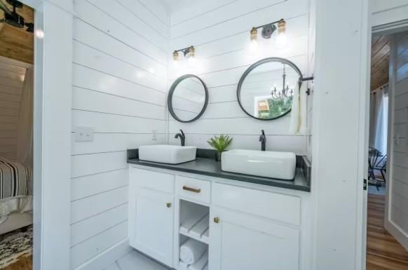 119 Leadwood Trl, Broken Bow, OK 74728 - bathroom with wood walls, a sink, and double vanity