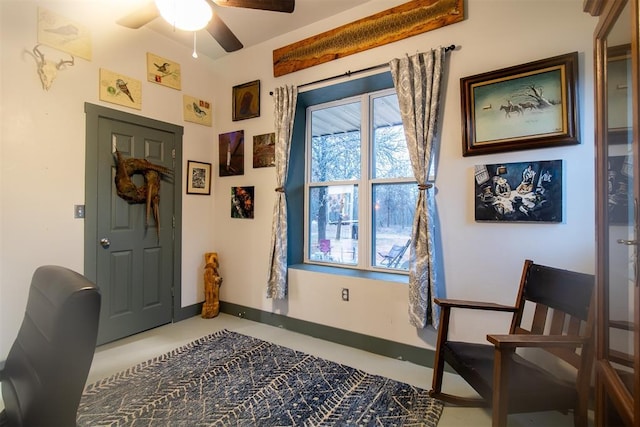 interior space featuring ceiling fan and baseboards
