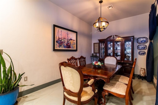 dining area featuring baseboards, a notable chandelier, and visible vents