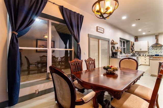 dining space with recessed lighting, a notable chandelier, and visible vents