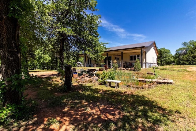 back of property featuring a yard and a patio area